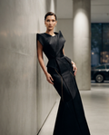 An architectural masterpiece. Crafted from premium silk-crepe, this obsidian-black gown defines modern elegance with its structured silhouette. Minimalist, bold, and timeless.